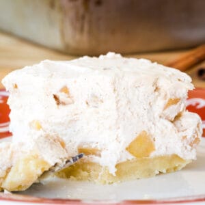 A closeup of one of the Gluten-Free No Bake Apple Cheesecake Bars with a small bite on a fork.