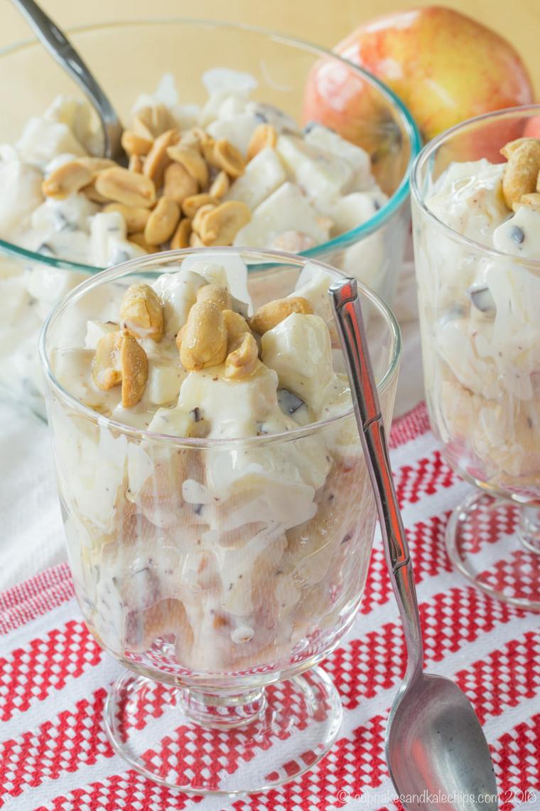 glasses filled with apple candy bar salad and topped with peanuts