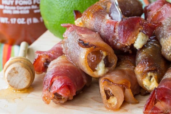 Sweet and Spicy Blue Cheese Bacon Wrapped Dates coated in a honey lime sriracha glaze will be your new favorite party appetizer recipe!