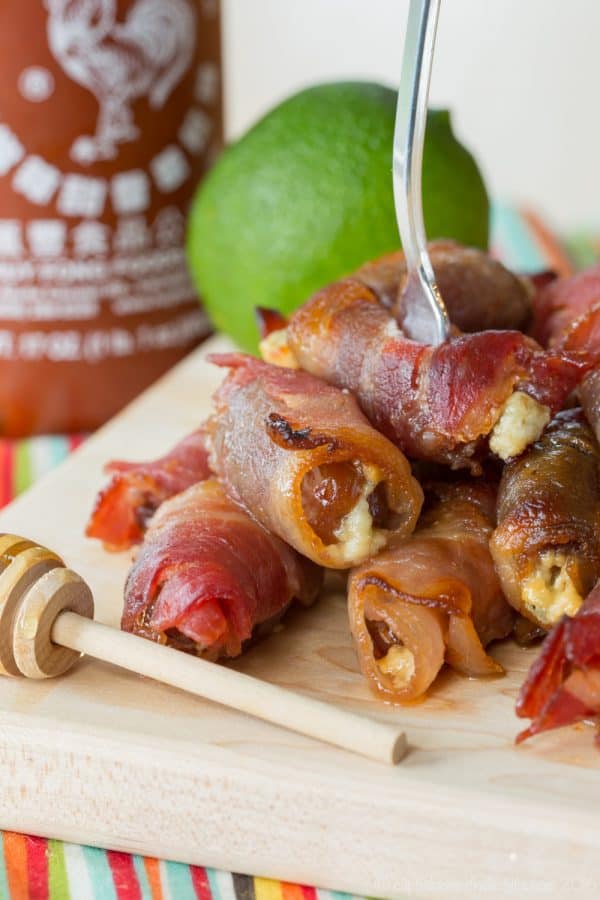 Sweet and Spicy Blue Cheese Bacon Wrapped Dates coated in a honey lime sriracha glaze will be your new favorite party appetizer recipe!