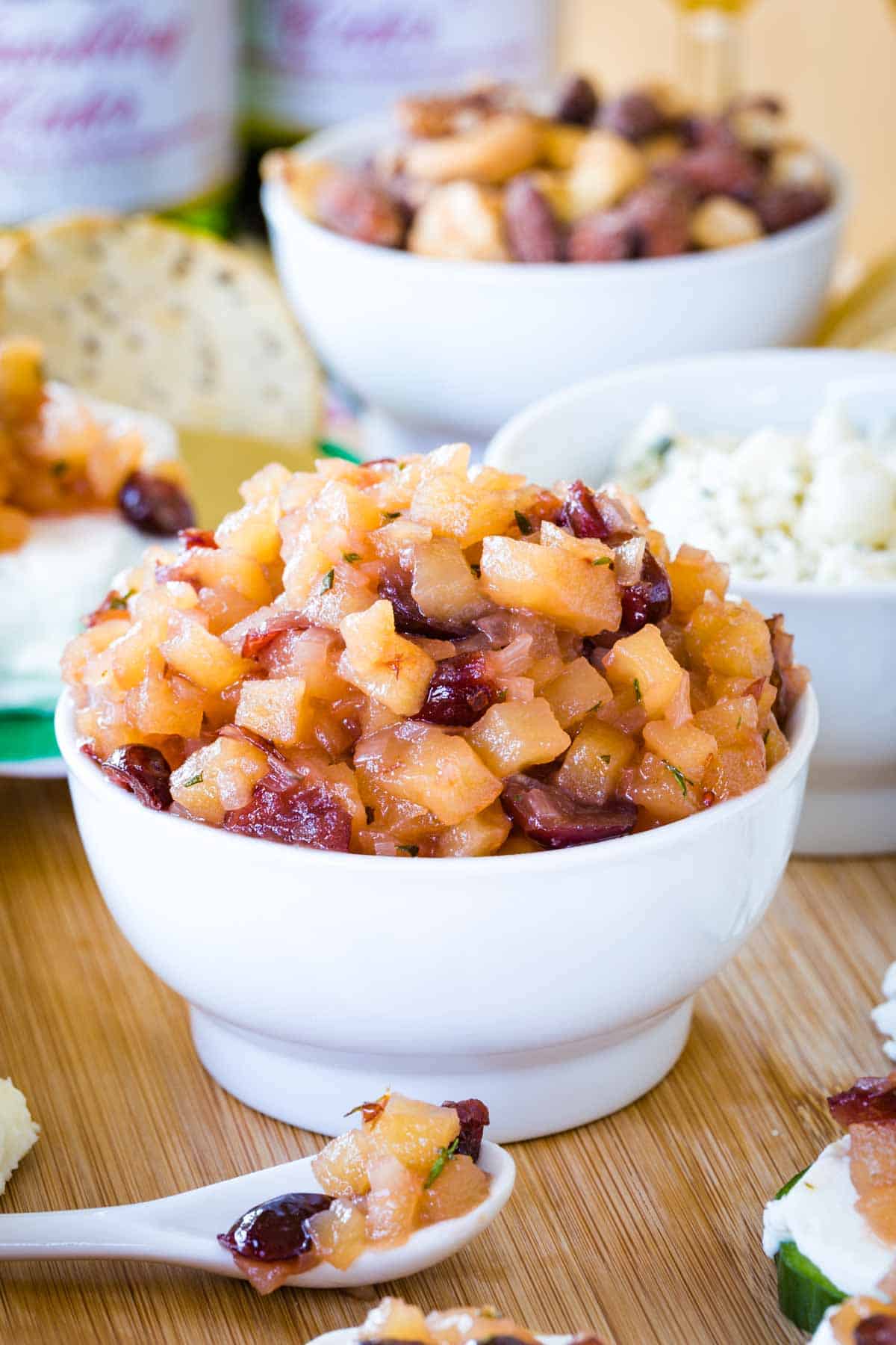 A closeup of a bowl of apple chutney with cranberries in it.