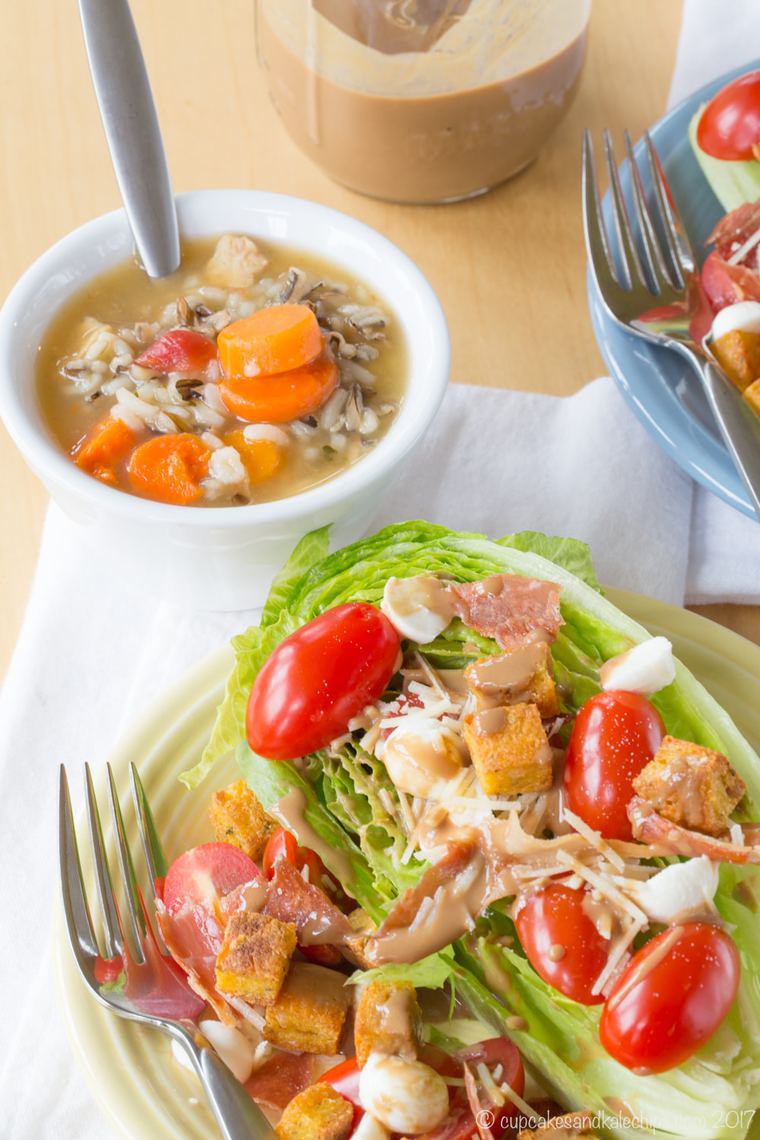 Italian-style wedge salad with romaine lettuce, tomatoes, mozzarella, parmesan, and crispy prosciutto served with soup