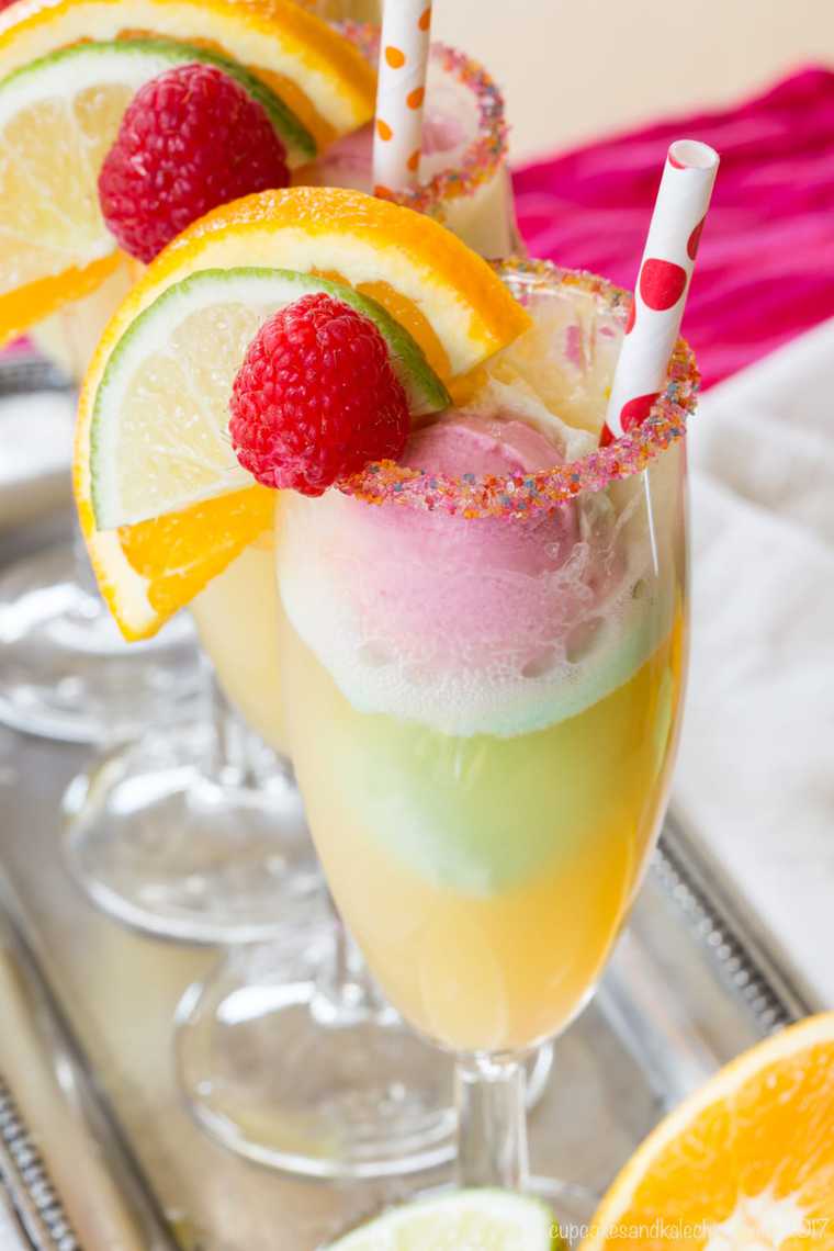 A Rainbow Sherbet Float Garnished with a Lime Slice, an Orange Slice and a Raspberry