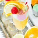 A closeup of a Sparkling Cider Float with small scoops of rainbow sherbet.