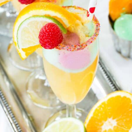 A closeup of a Sparkling Cider Float with small scoops of rainbow sherbet.