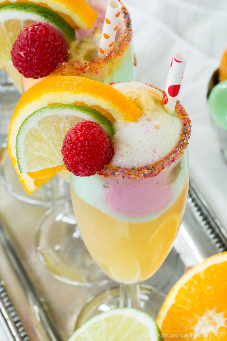 A Sparkling Cider Sherbet Float with Rainbow Sugar on the Rim of the Glass and Fresh Fruit Garnishes