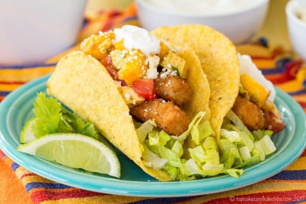 A plate of two Chili Lime Fish Stick Tacos with Mango Avocado Salsa