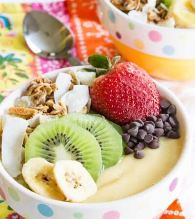 Tropical Smoothie Bowl topped with fresh fruit, chocolate chips, and granola