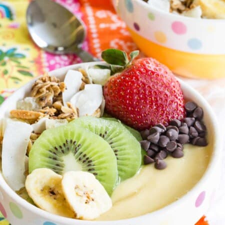 Tropical Smoothie Bowl topped with fresh fruit, chocolate chips, and granola