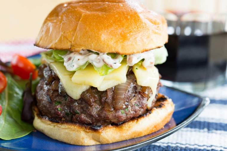 French Onion Stuffed Cheeseburger au Gratin on a blue plate