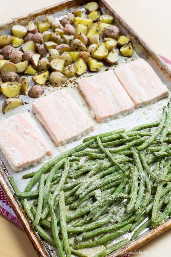 Pesto Salmon Sheet Pan Dinner with Potatoes and Green Beans - an easy dinner recipe that's ready in less than forty minutes with only one pan to clean up. This seafood sheet pan meal made with @GortonsSeafood is a healthy and gluten free addition to your weekly meal plan. #AD