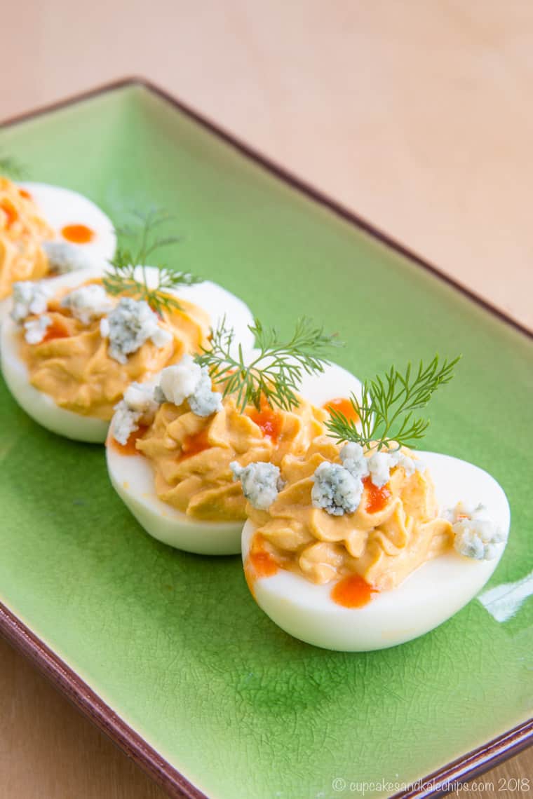 Buffalo Blue Cheese Deviled Eggs on a green plate