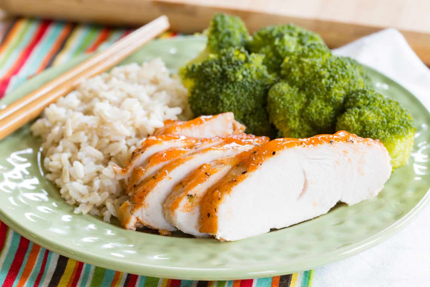 Sriracha Lime Crock Pot Turkey Tenderloin sliced on a plate with chopsticks