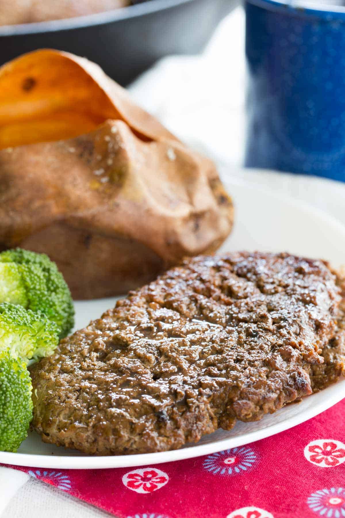 Pan seared cube steak on a plate with side dishes.