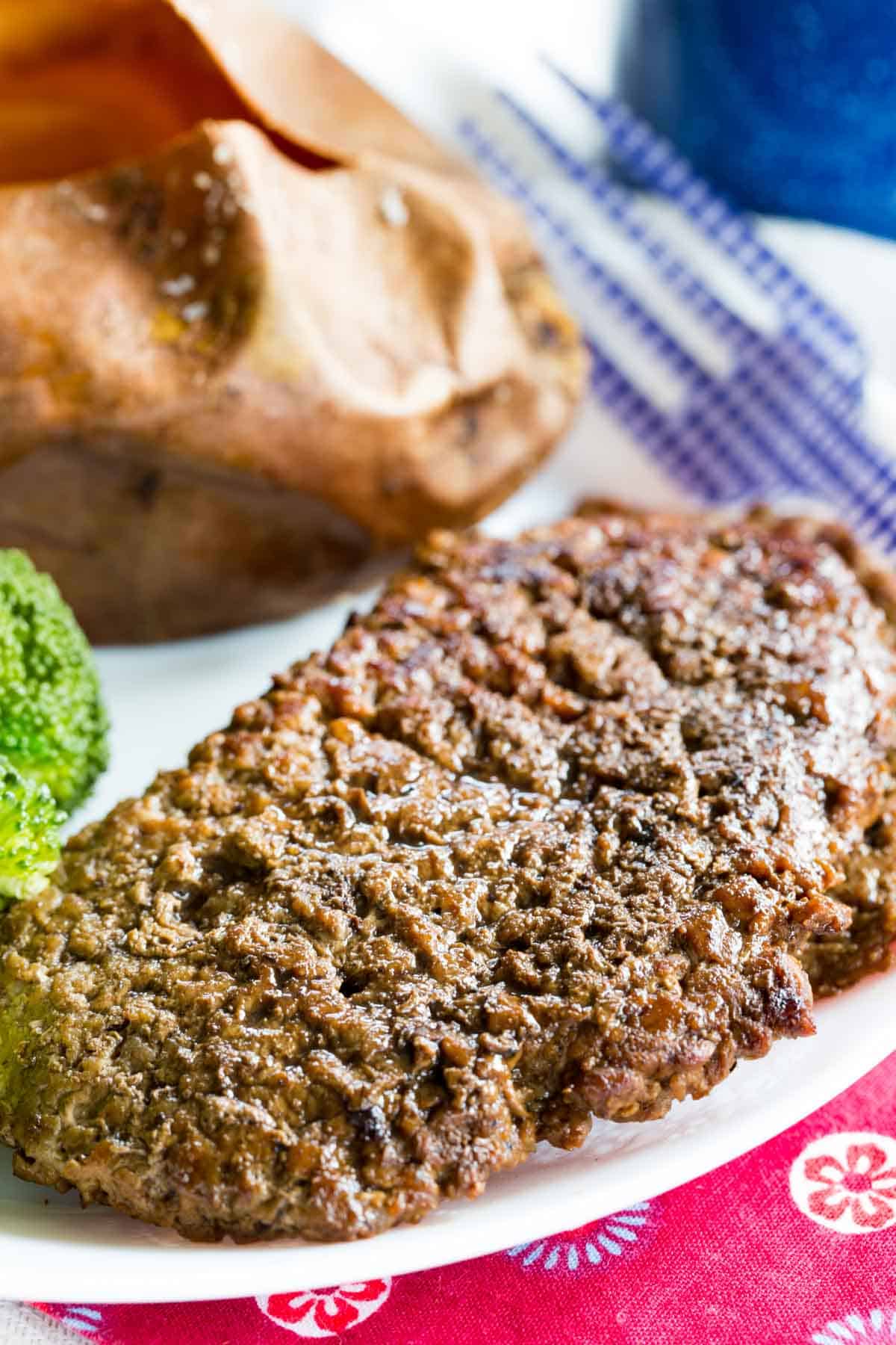 A closeup of a pan seared Cubed Steak on a plete.