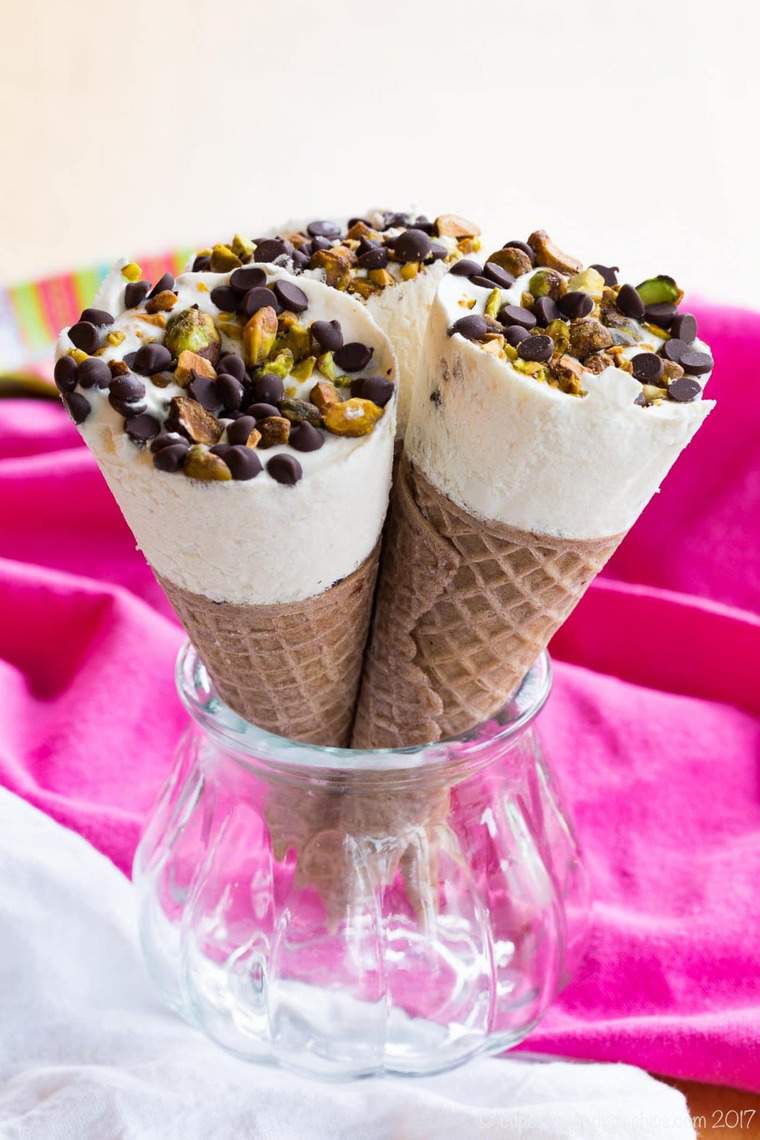 Cannoli Ice Cream Cones - fill sugar cones with a no-churn cannoli ice cream made with ricotta cheese and sprinkle with chocolate chips and pistachios.