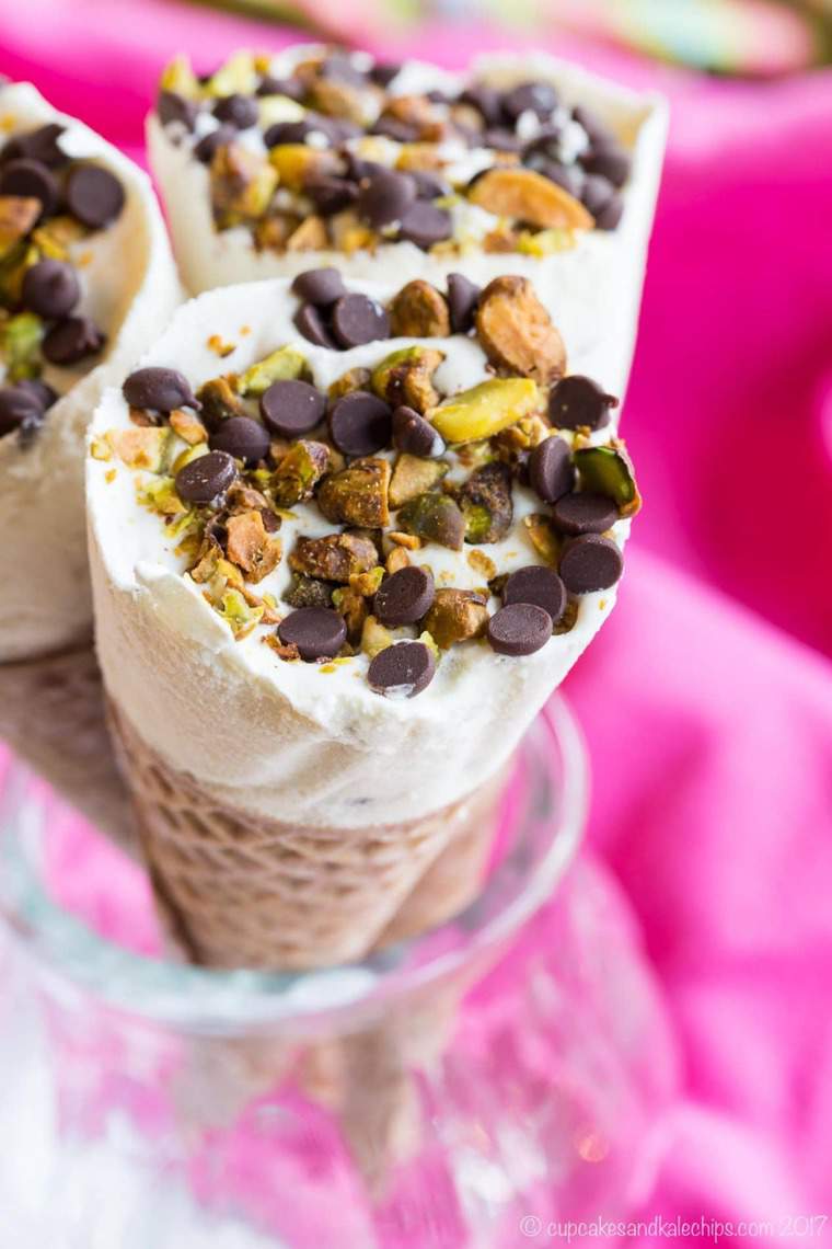Cannoli Ice Cream Cones - fill sugar cones with a no-churn cannoli ice cream made with ricotta cheese and sprinkle with chocolate chips and pistachios for a fun frozen twist on the classic Italian dessert.