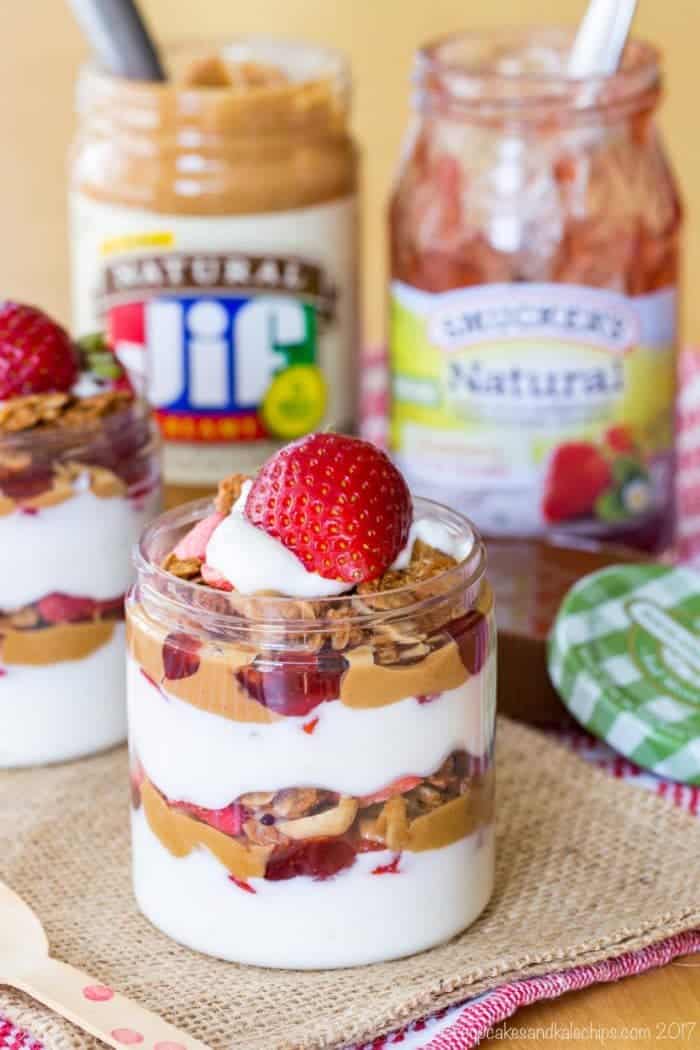 Peanut Butter and Jelly Parfaits with Greek Yogurt, layers of strawberries, Jif Natural Creamy Peanut Butter, Smucker's Natural Strawberry Fruit Spread, and PB&J granola. #PBJlove. #ad 