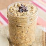 A jar of pumpkin overnight oats topped with cacao nibs with text overlay that says "Pumpkin Spice Latte Overnight Oats".