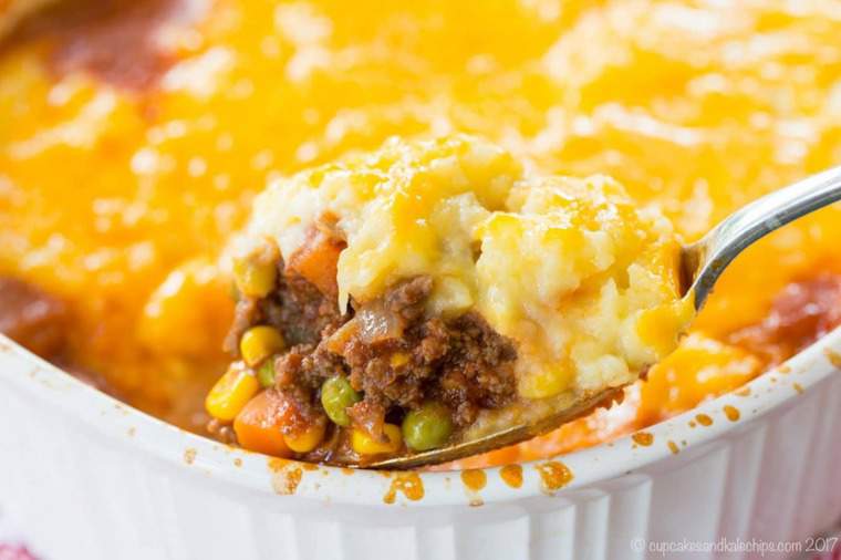 Scooping Shepherds Pie out of a baking dish