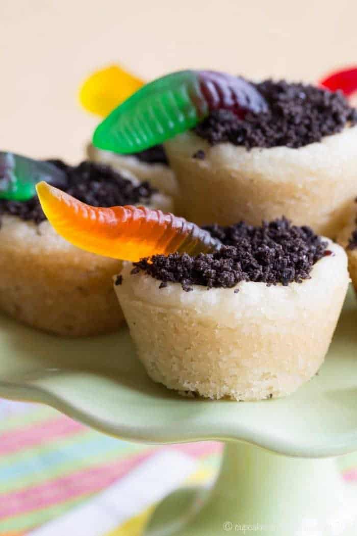 Closeup of sugar cookie cup filled with Oreo dirt and gummy worms