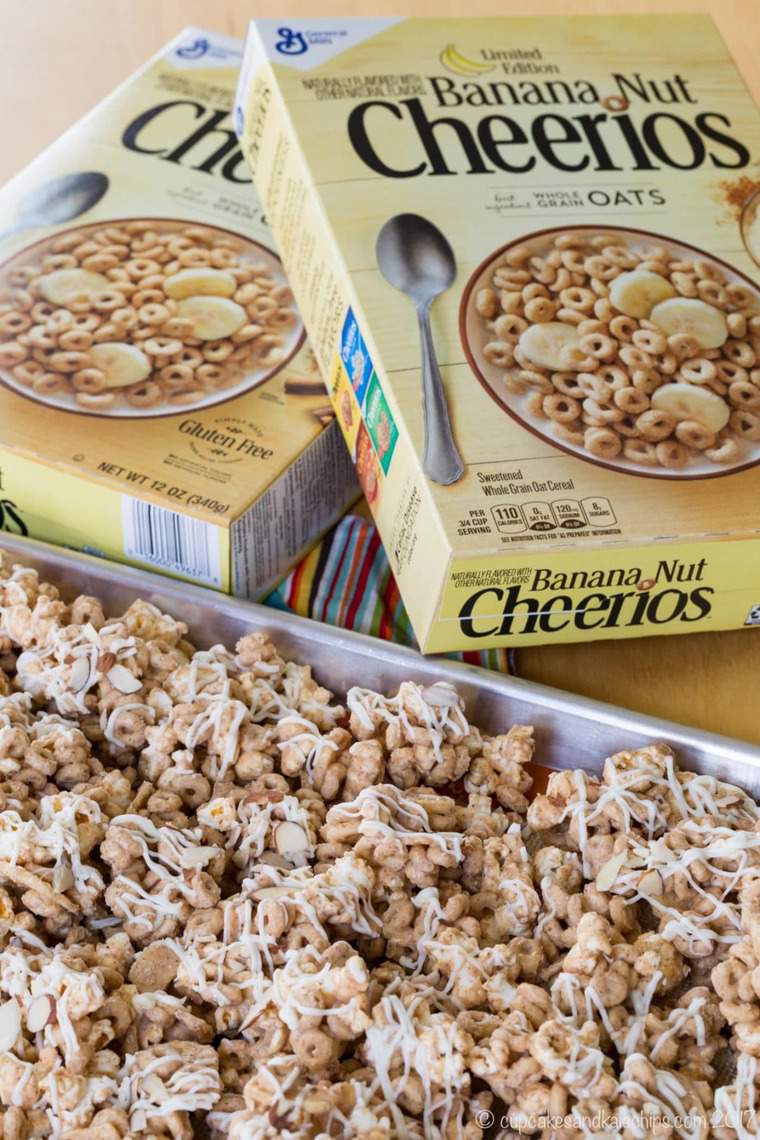 A tray filled with gluten-free Banana Nut Cheerios popcorn snack mix next to boxes of Cheerios.