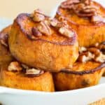 Pumpkin Pie Spice Melting Sweet Potatoes with maple glazed pecans on in a casserole dish
