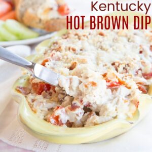 knife scooping up cheesy Kentucky Hot Brown Dip