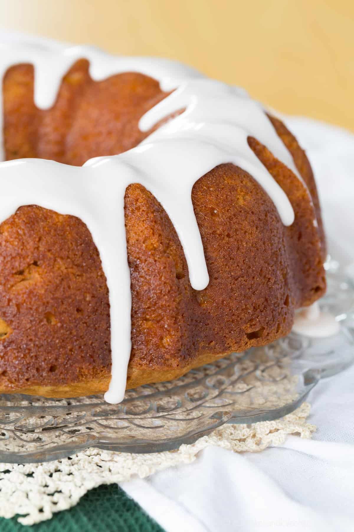 apple bundt cake with white icing dripping over the sides