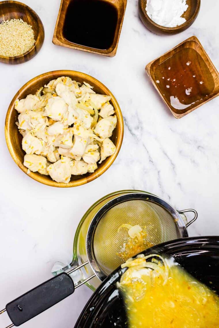 Straining the liquid from the chicken