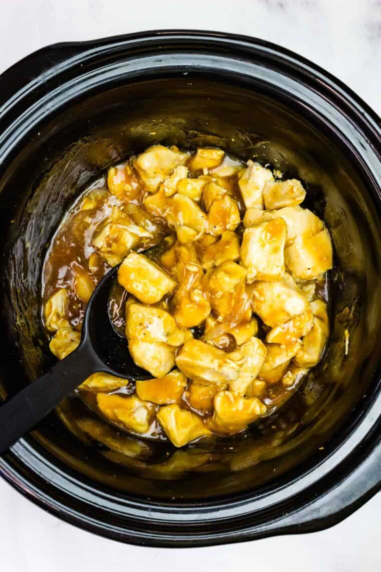 Stirring orange chicken in the crockpot
