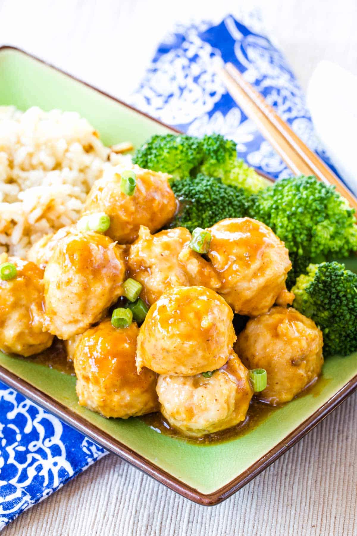 General Tso's Chicken Meatballs served over zoodles, brown rice, and steamed broccoli.