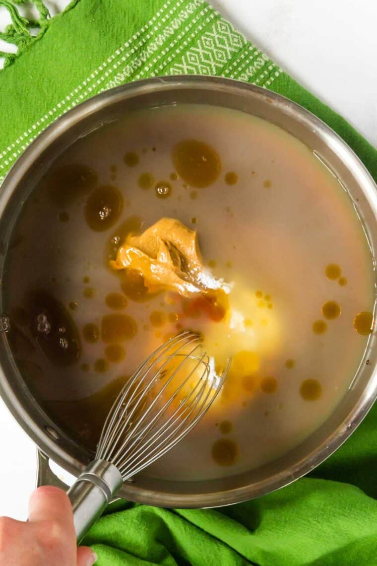 A whisk is used to combine the sauce ingredients.