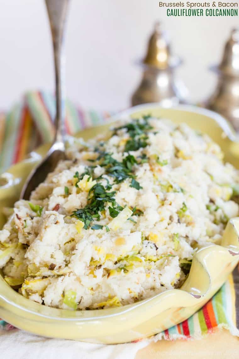 Cauliflower colcannon in a serving bowl with a metal spoon.