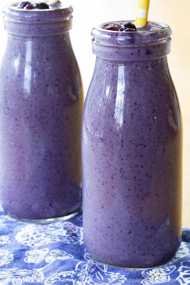 Blueberry smoothie with almond butter in a glass bottle