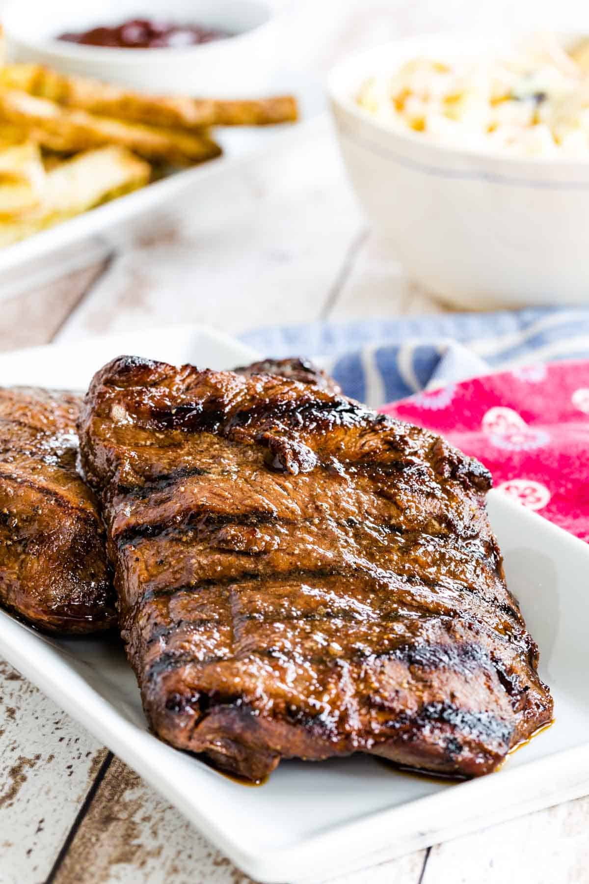 two grilled steaks on a serving plate