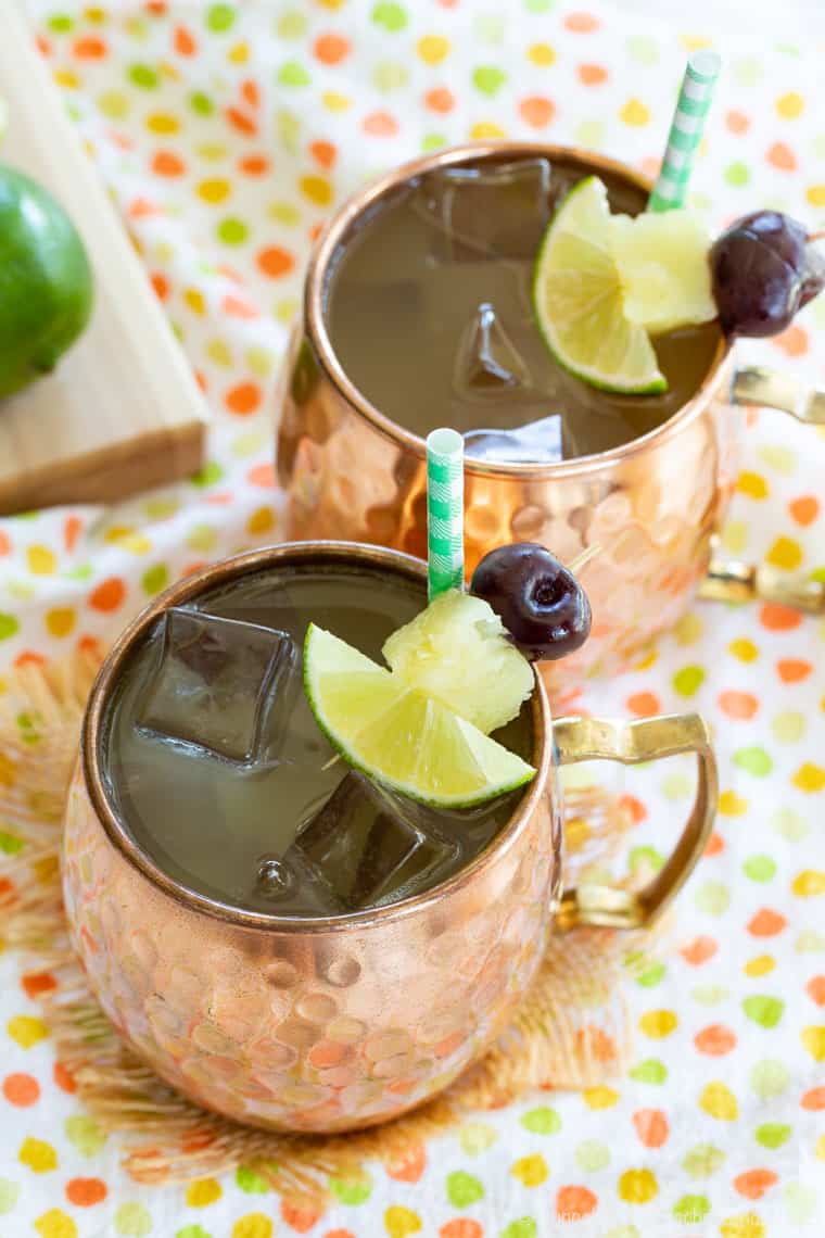 Pina Colada Mules from overhead with cherry, pineapple, and lime garnish