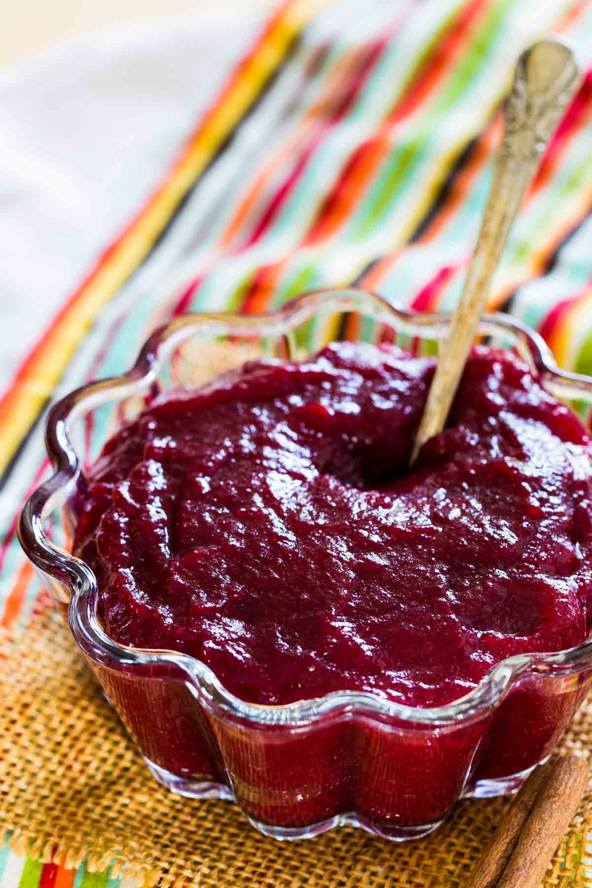 Homemade cranberry sauce in a dish with a spoon