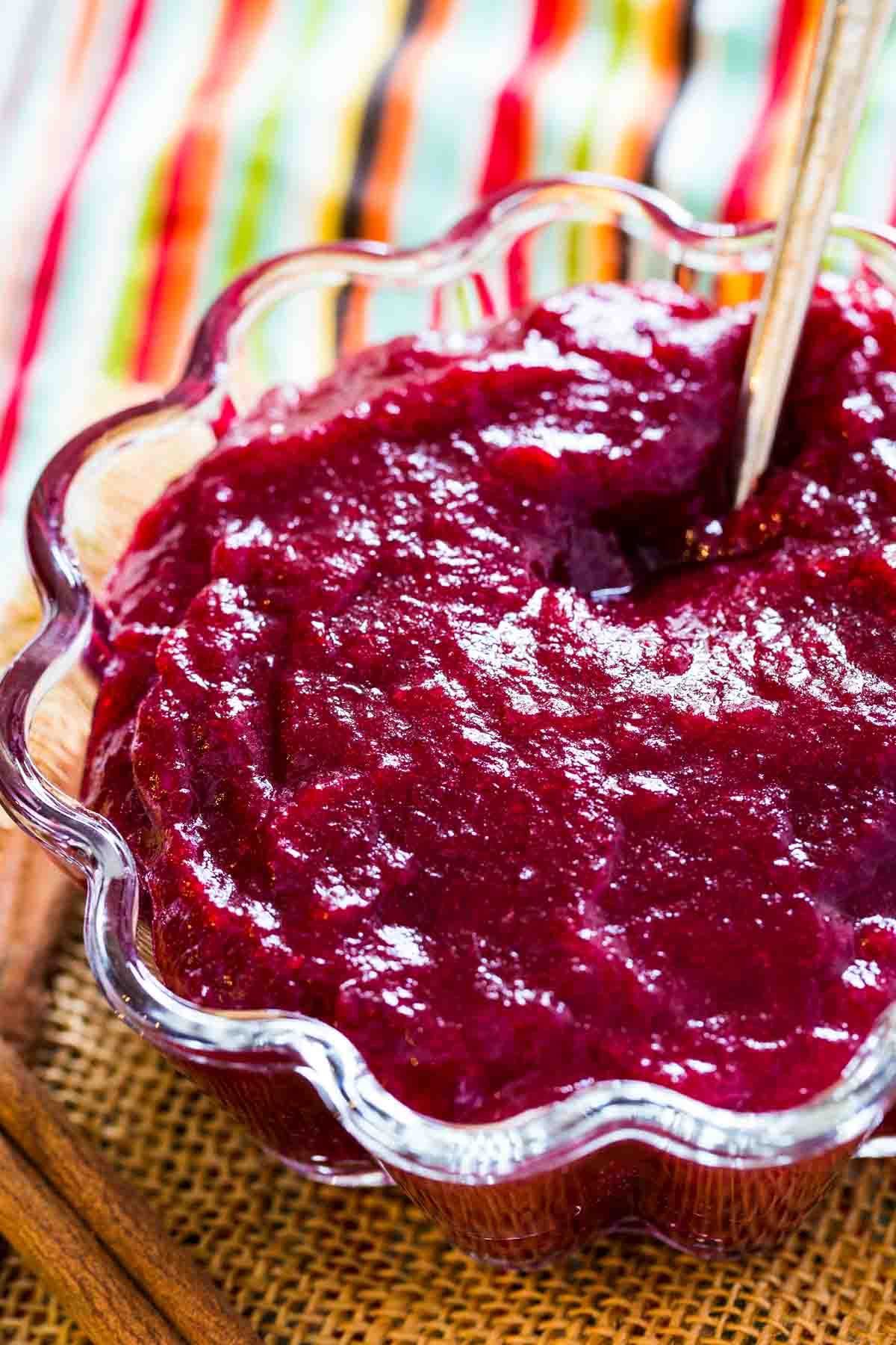 Gorgeous crimson-colored Cranberry Sauce with Orange Juice and Cinnamon with a striped napkin