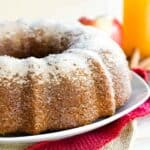 Gluten Free Apple Cider Donut Cake on a white plate with a cake server