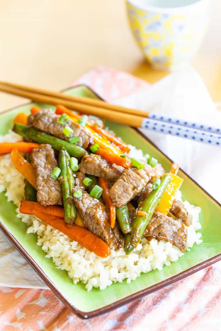 Gluten Free Beef Stir Fry with bright colored veggies on a plate with chopsticks