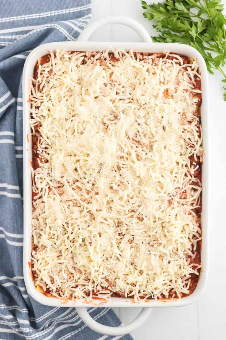 Cheese on top of layers of lasagna in a pan
