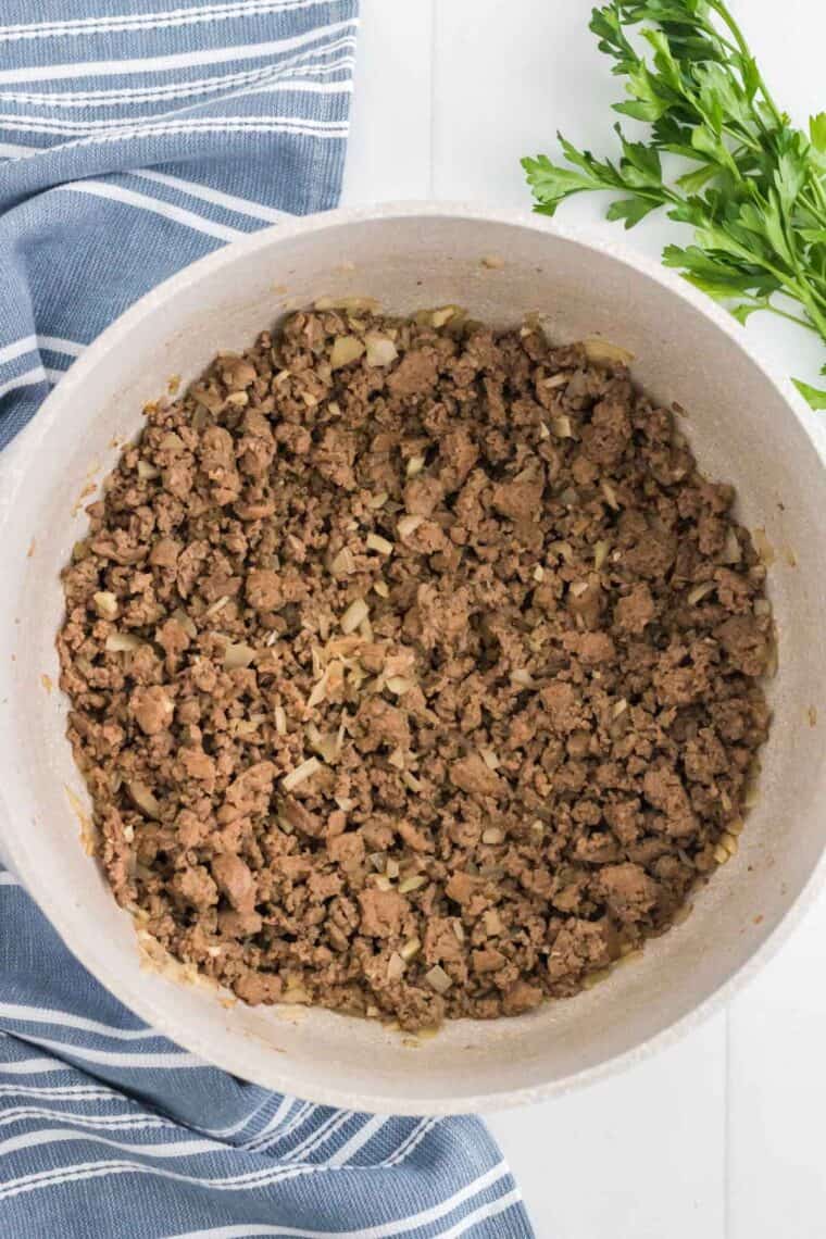 Cooked ground beef and onions with sausage