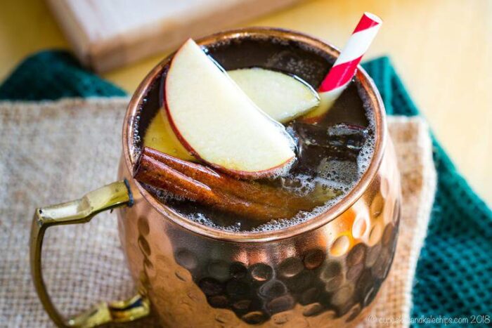 Fall cocktail in a copper mug with a straw