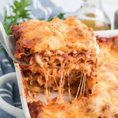 A slice of lasagna being lifted out of pan