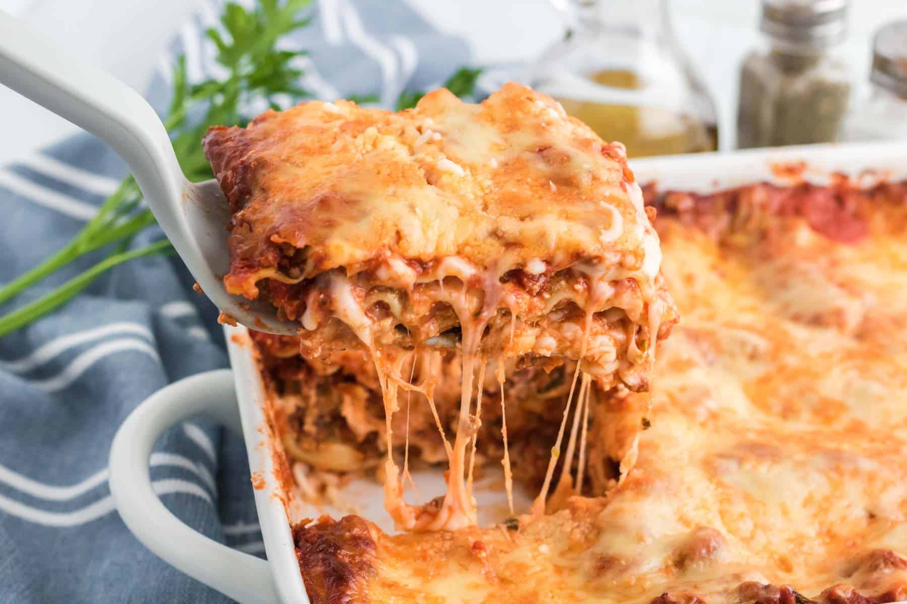 A slice of lasagna being lifted out of pan