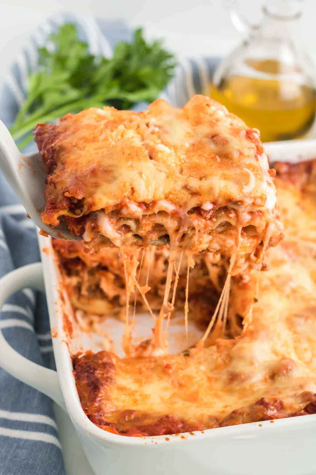 A slice of lasagna being lifted out of pan