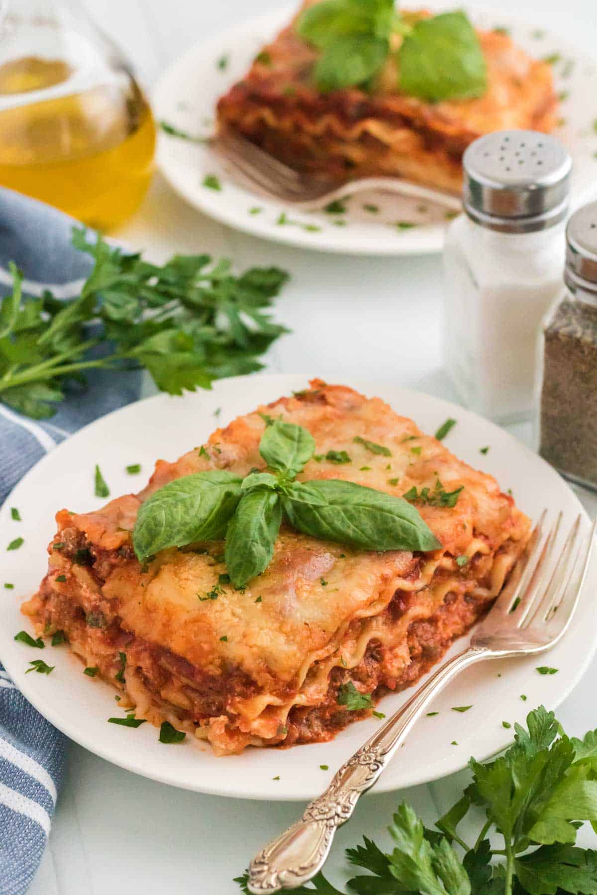 Slices of homemade lasagna on white plates