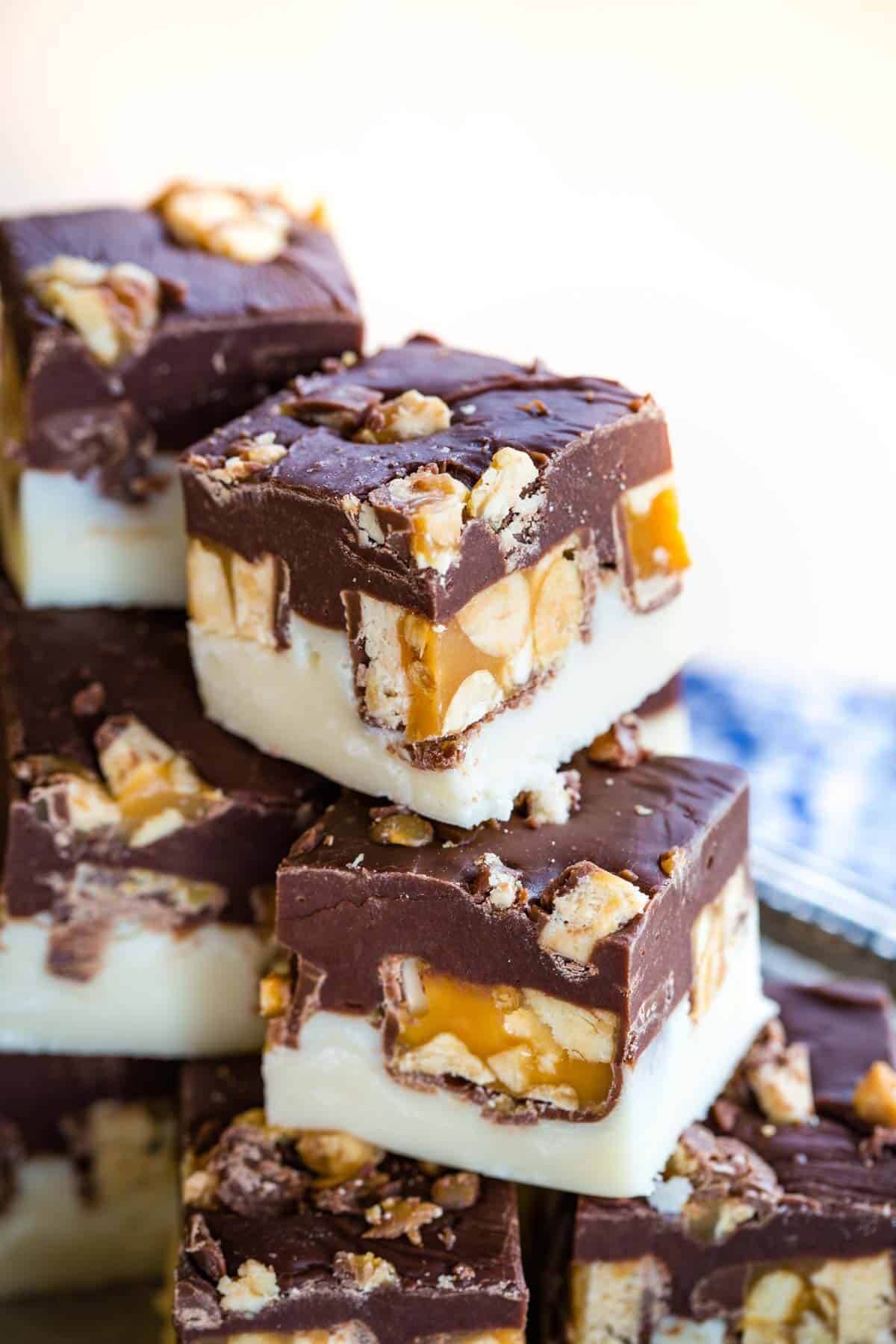 Candy Bar Fudge Recipe Stuffed with Snickers stacked up.