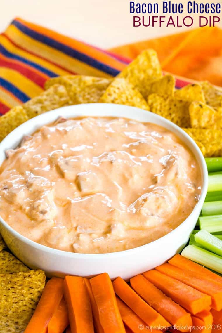 Bacon Blue Cheese Buffalo Dip on a platter with tortilla chips, carrots, and celery